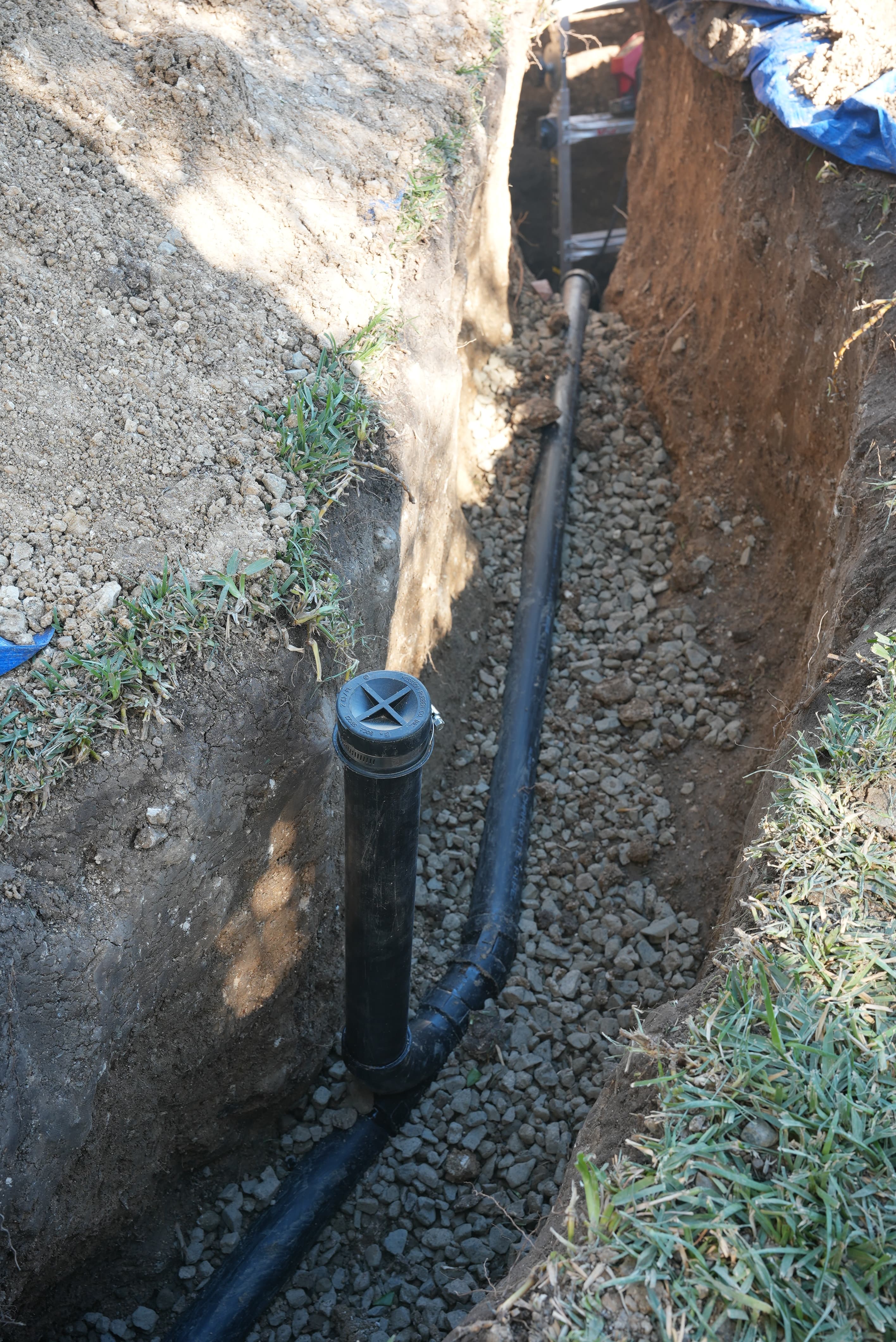 Redrain installation — new pipes routed around damaged lines